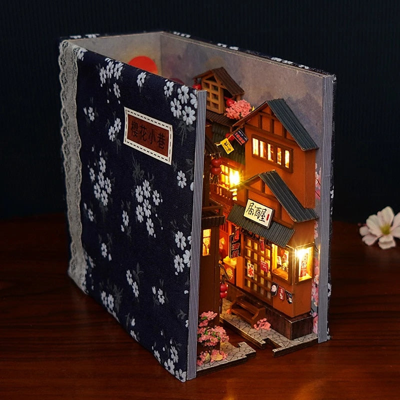 https://themissingpiece.shop/cdn/shop/files/NEW-DIY-Book-Nook-Cherry-Blossom-Alley-Bookend-Book-Shelf-Insert-Bookcase-Assembled-Building-Kit-Toy.jpg_Q90.jpg__1_6a765b8d-ca5c-4e2b-a4ce-1cd8a32aa593.jpg?v=1699466529&width=800